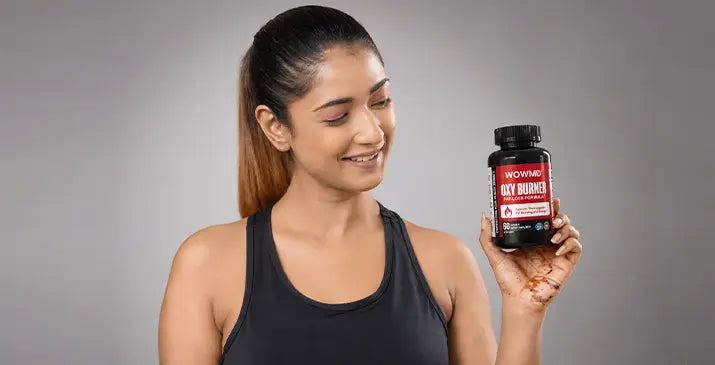Woman holding WOWMD Oxy Burner, best diet pills for weight loss and metabolism support